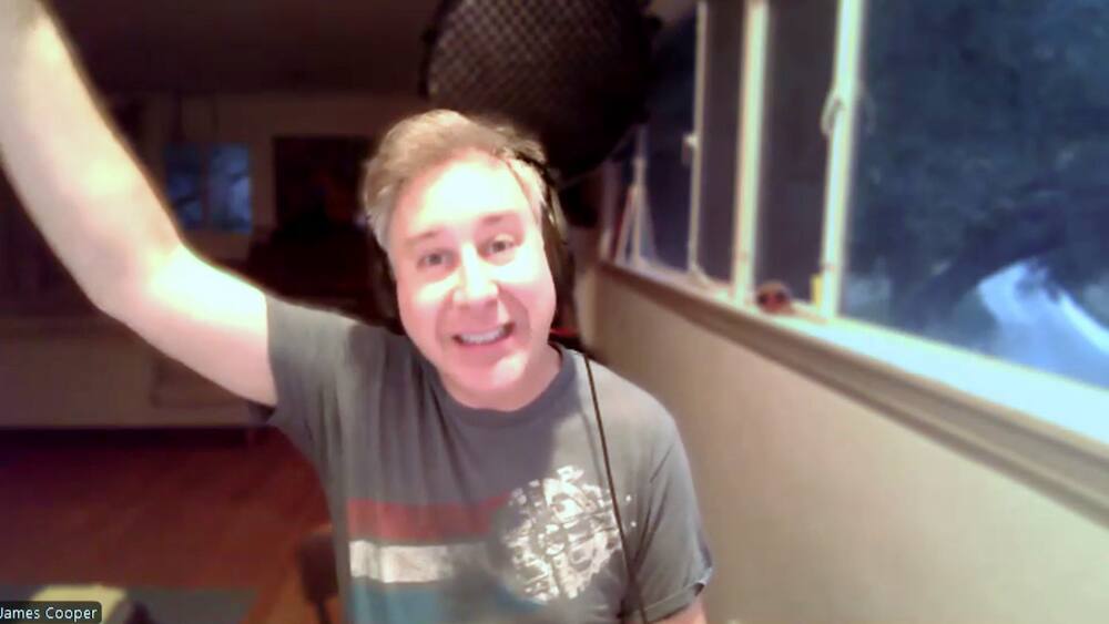 James Cooper with his arm raised, mid-explanation.